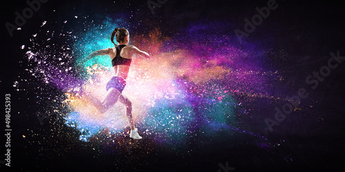 Athletic woman runner on colourful background