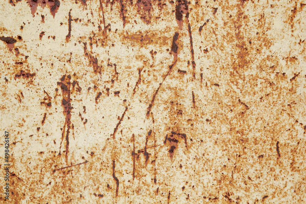 Fototapeta premium Brown beige abstract textured background with red hues. A weathered, rust-eaten textured sheet of metal with traces of paint residue.