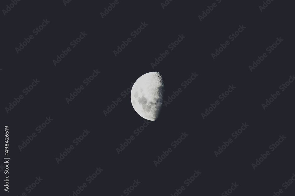 half moon in the night sky shot with telephoto lens half moon in the night sky shot with telephoto lens