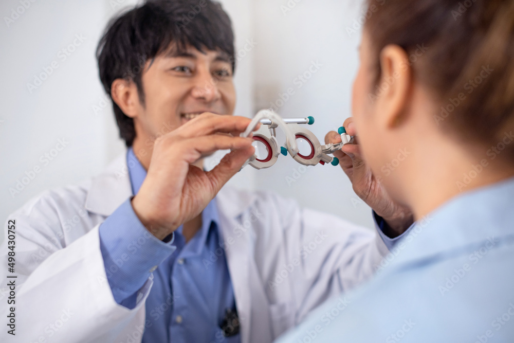 Optometrist examines senior woman's eyesight with trial frame in modern clinic, selective focus Optometrist examines senior woman's eyesight with trial frame in modern clinic, selective focus
