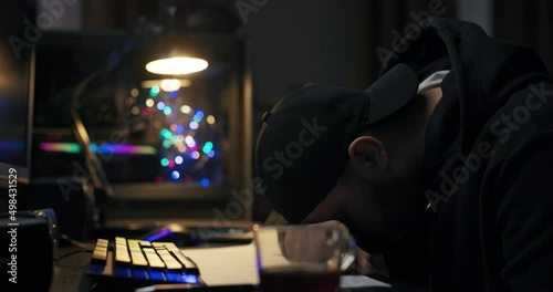 Student while studying for exams fell asleep at night on desk with cup of coffee, a man wakes up looking around confused rubbing eyes, a computer scientist looks at computer.