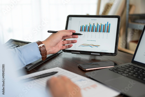 Business hands pointing for checking report chart. Businessman analyzing financial report company and calculate profit with report summary.