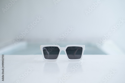 white glasses on the edge of the swimming pool