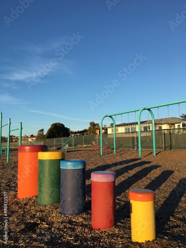 kids playground with rainbow colored tubes and swing set