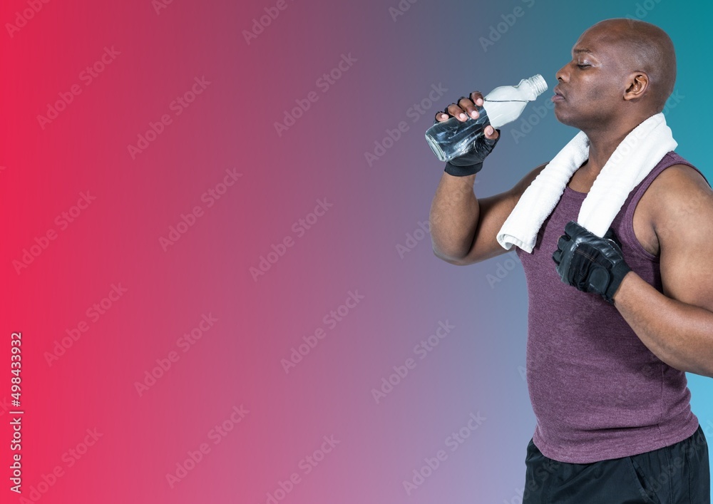 African american fit man drinking water against copy space on blue and pink gradient background African american fit man drinking water against copy space on blue and pink gradient background