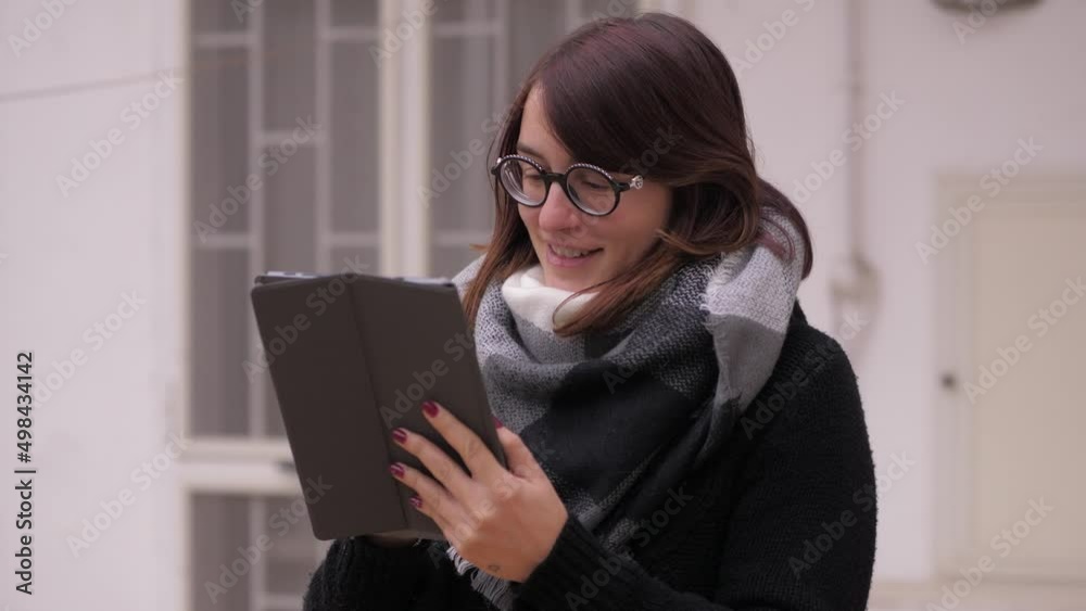 Young caucasian woman using tablet computer touchscreen outdoor Young caucasian woman using tablet computer touchscreen outdoor