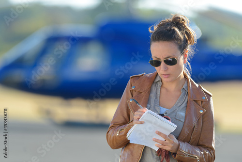 beautiful woman pilot with paperwork before flying photo