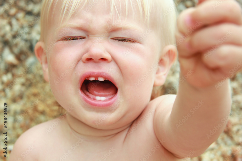 Crying baby with teething teeth, face close-up. Whims and tantrums Crying baby with teething teeth, face close-up. Whims and tantrums