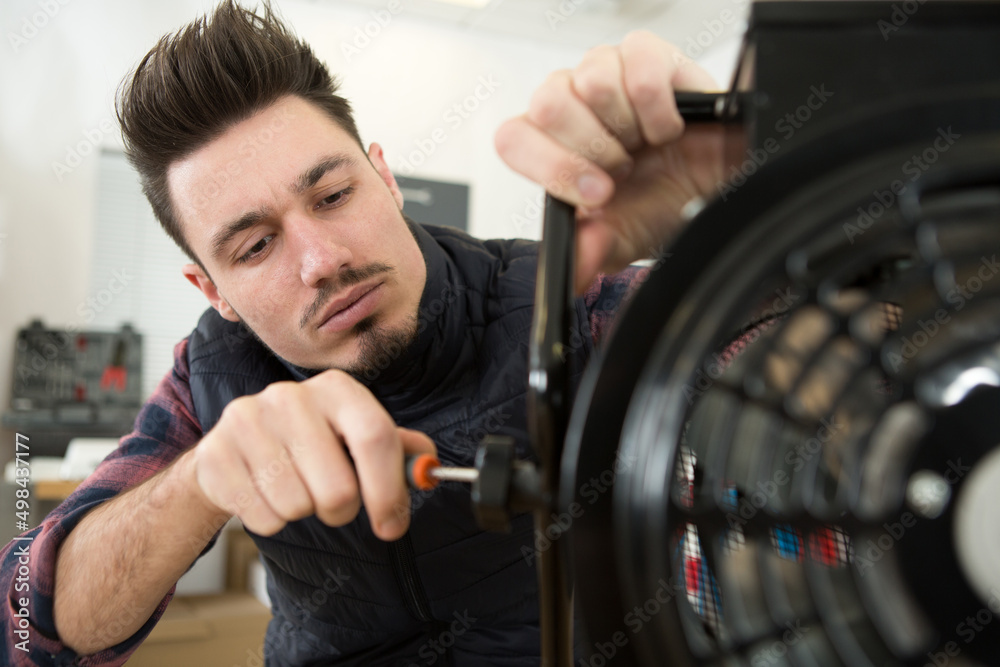 a man is fixing the ventilator a man is fixing the ventilator