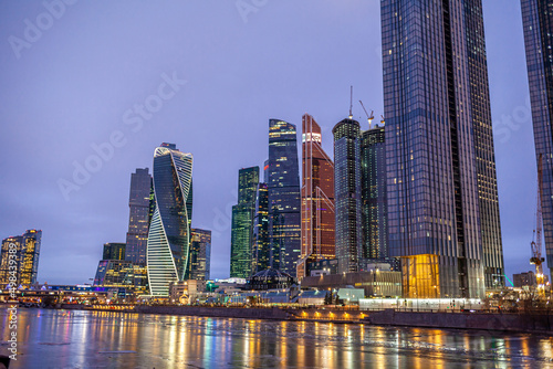 April 1, 2022, Moscow Russia. Moscow City International Business Centre skyscraper buildings with panoramic windows night view. Moscow City at night. Lights are reflected in the river.