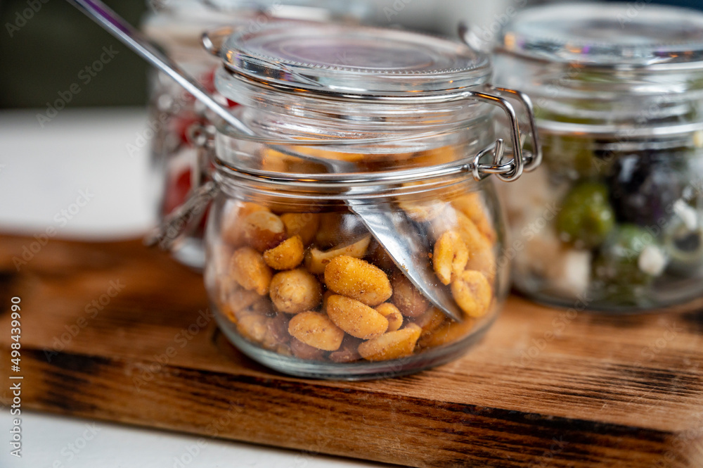 Glass jars with healthy party snacks served in bar, tasty appetisers