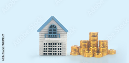 Model house mock up and coins. property real estate investment concept