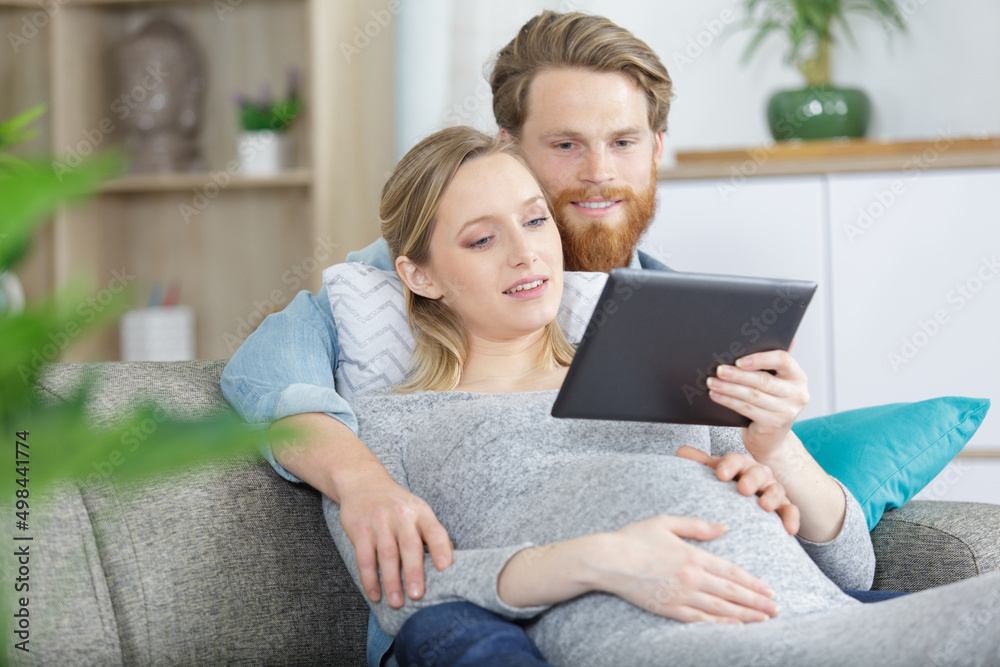 happy family is watching video on tablet and smiling happy family is watching video on tablet and smiling
