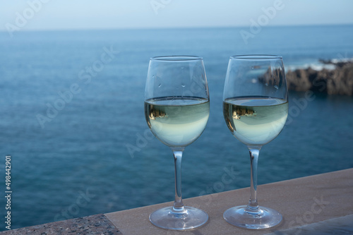 Drinking of white wine with view on blue Atlantic ocean on Tenerife, Canary islands, Spain