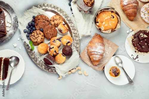 Dessert table with all kinds snacks on light background.