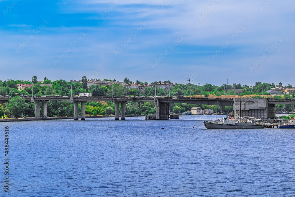 Fototapeta premium View of the Inhulskyy Mist bridge from the Pedestrian bridge across the Inhul river in Mykolaiv, Ukraine. Urban panorama of Ukrainian town