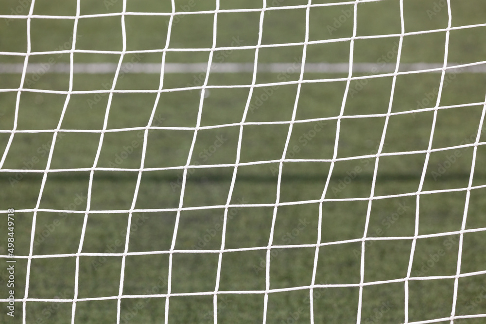 Football ( soccer ) net with green grass background