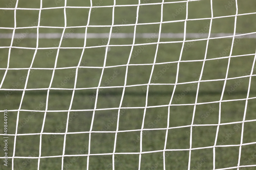 Football ( soccer ) net with green grass background Football ( soccer ) net with green grass background