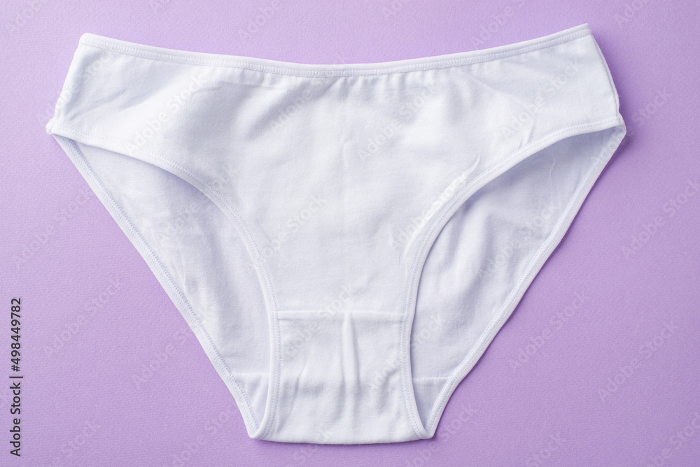 Top view photo of white cotton classic panties on isolated pastel violet background - obrazy, fototapety, plakaty 