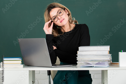 Teacher in classroom at university or college. Female beautiful student on board with computer laptop. Lesson seminar skills. Young woman study in high school.