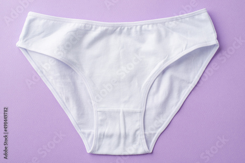 Top view photo of white cotton classic panties on isolated pastel violet background