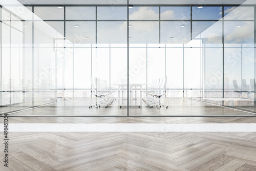 Luxury glass office interior with city view, daylight, furniture and wooden flooring. Workplace concept. 3D Rendering. photo