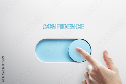 Close up of male finger turning on slider button on white background. Confidence and success concept. photo