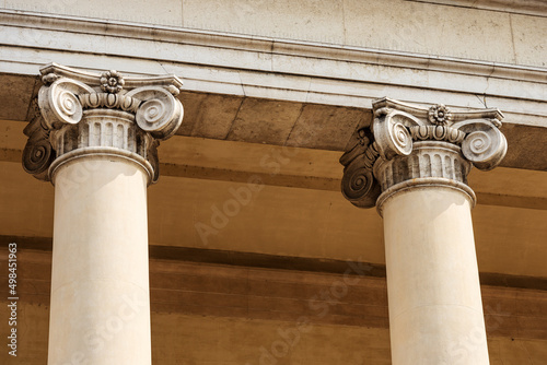 Close-up of two columns with Ionic capitals. Facade and pronaos of Treviso Cathedral (Duomo o Cattedrale di San Pietro Apostolo - Saint Peter the Apostle), VI-XIX century, Veneto, Italy, Europe. photo