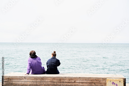 couple sitting on the pier