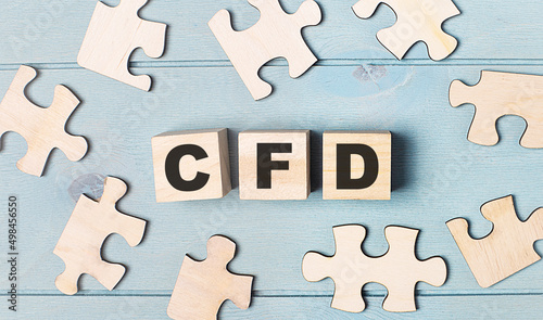 Blank puzzles and wooden cubes with the text CFD Contract for Difference lie on a light blue background.