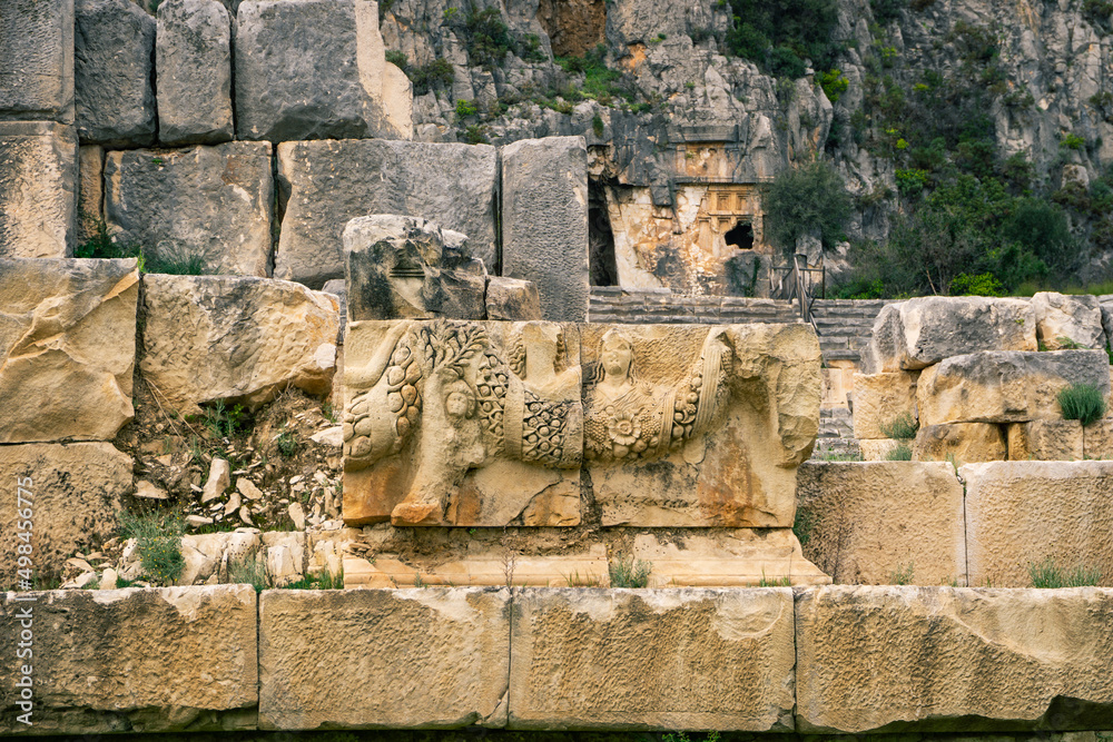 Myra Ancient City. Preserved bas-reliefs with floral ornaments and faces. Demre, Antalya, Turkey