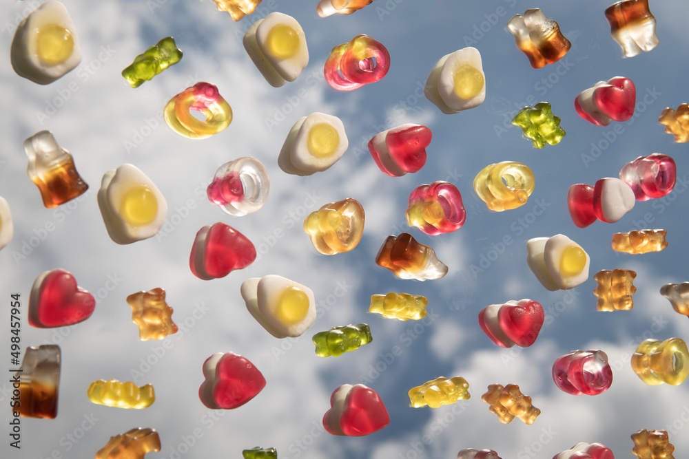 abstract fine art photo of colorful candy on mirror reflecting the sky abstract fine art photo of colorful candy on mirror reflecting the sky