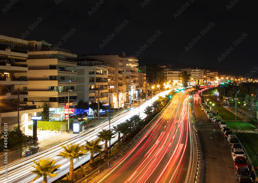 Cityscape, top view of the night Athens with illuminated strees and headlights, Greece