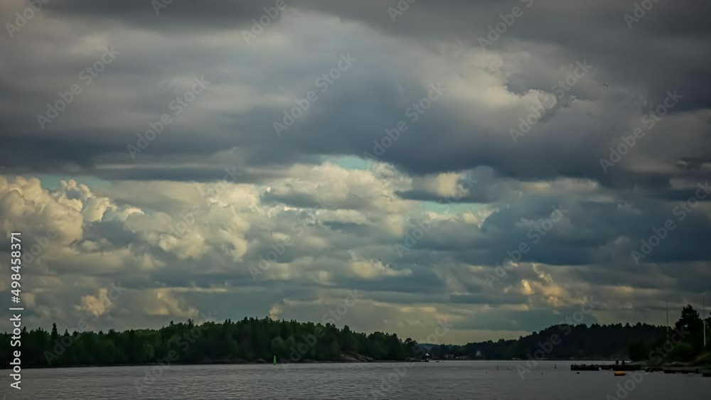 Static shot of cruise ships and sailing boats passing by on a cloudy evening. White clouds over hilly terrain surrounded by the river water.
Static shot of cruise ships and sailing boats passing by on a cloudy evening. White clouds over hilly terrain surrounded by the river water.