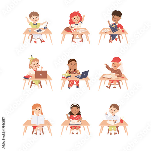 Primary School Pupils Sitting at Tables with Book and Notebook Engaged in Elementary Education Vector Set
