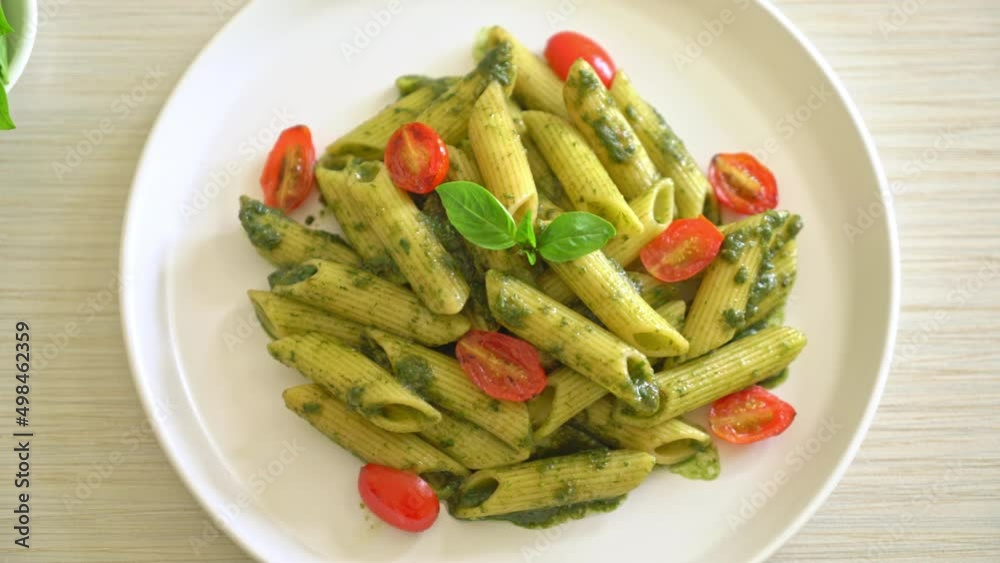 penne pasta with pesto sauce and tomatoes - vegan and vegetarian food style penne pasta with pesto sauce and tomatoes - vegan and vegetarian food style