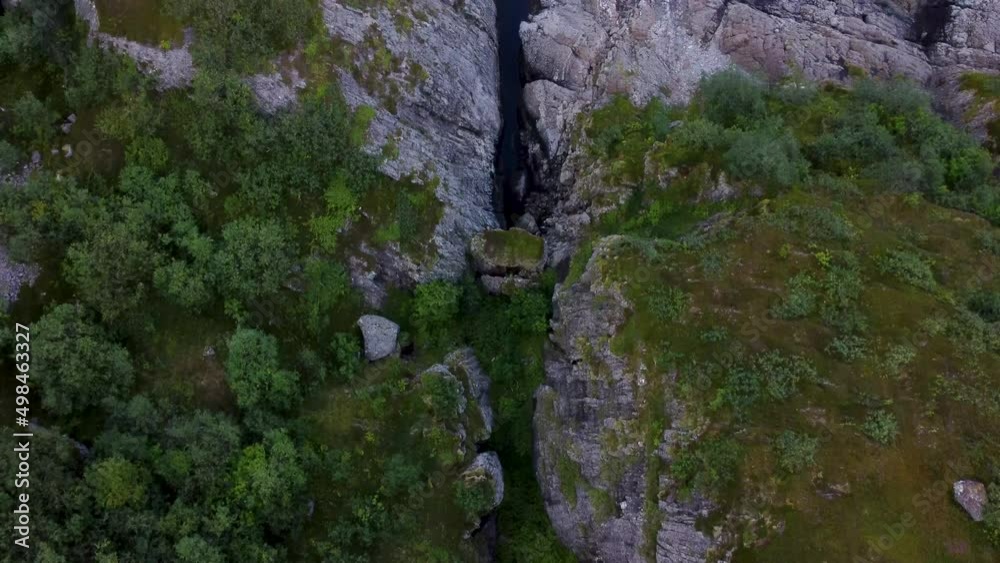 Flying over the shore of Nesland looking a the rocks and water then turning the camera up to see the mountains and the ocean Flying over the shore of Nesland looking a the rocks and water then turning the camera up to see the mountains and the ocean