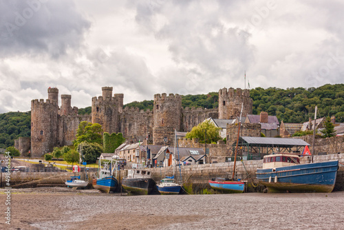 Conwy Castle and harbor at ebbtide photo