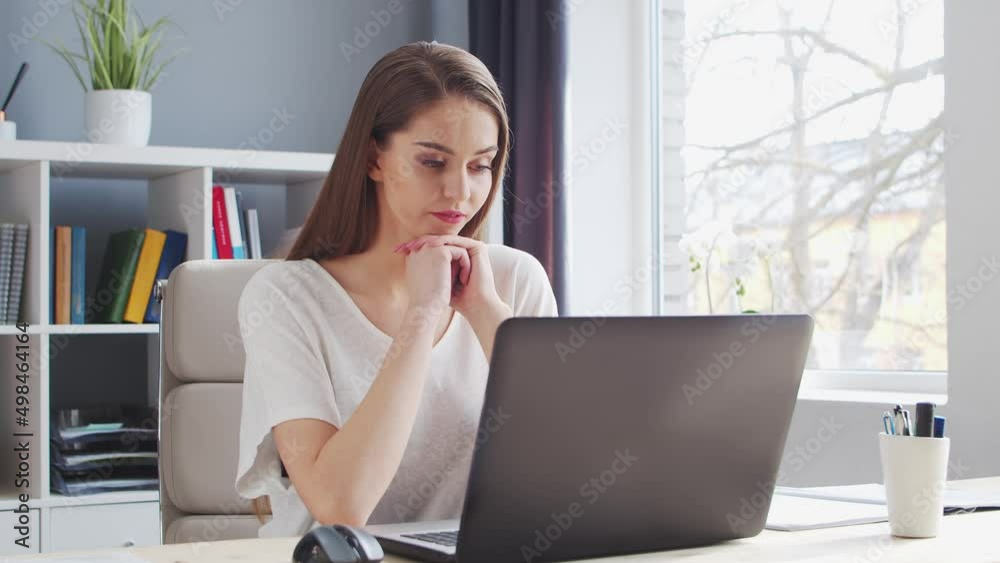 Young Woman Works at Home Office Using Computer. Workplace of Female Entrepreneur, Freelancer or Student. Remote Work and Education Concept. Young Woman Works at Home Office Using Computer. Workplace of Female Entrepreneur, Freelancer or Student. Remote Work and Education Concept.
