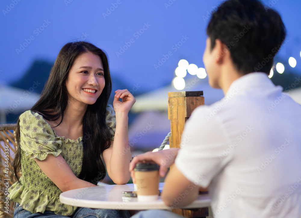 Image of young Asian couple dating at coffee shop Image of young Asian couple dating at coffee shop