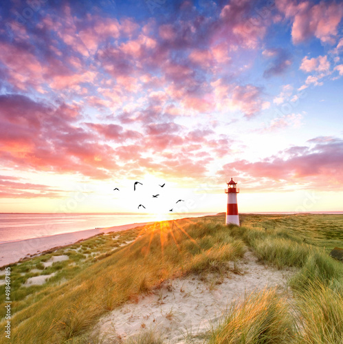 romantic lighthouse at the beach, sunrise