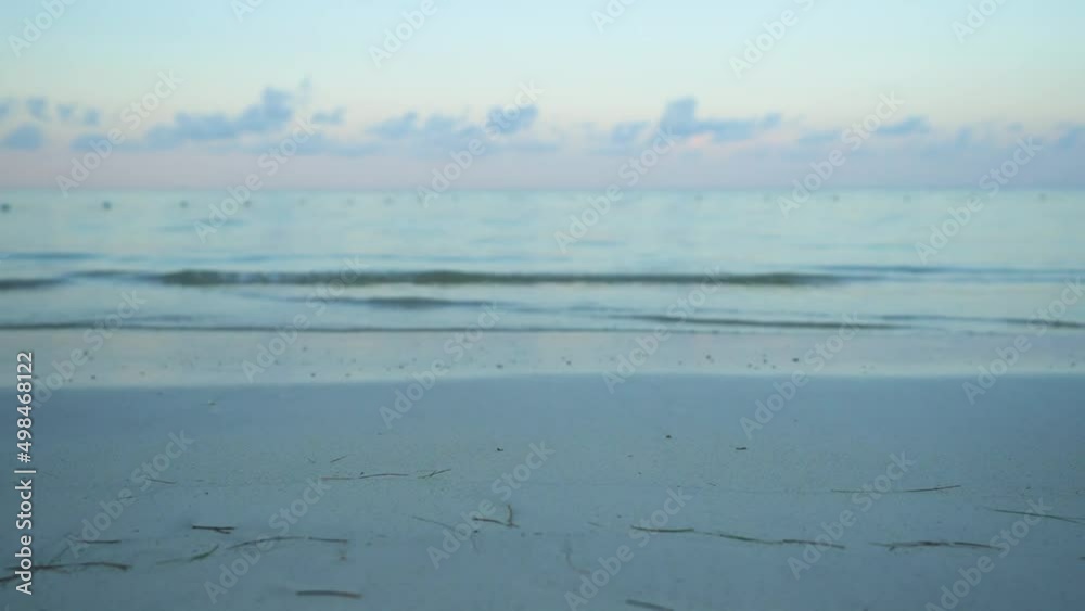 Gentle waves on beach at sunset Gentle waves on beach at sunset