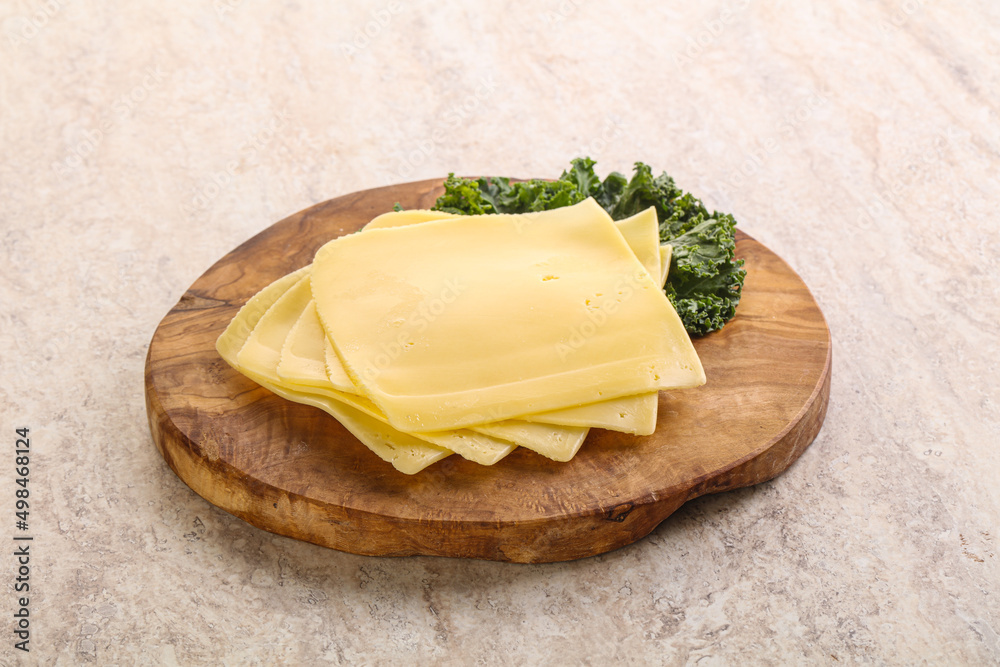 Sliced Gouda cheese over board Sliced Gouda cheese over board