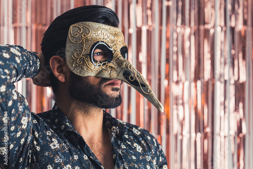 bearded man in traditional Venice mask with big nose medium closeup indoors carnival concept. High quality photo © PoppyPix