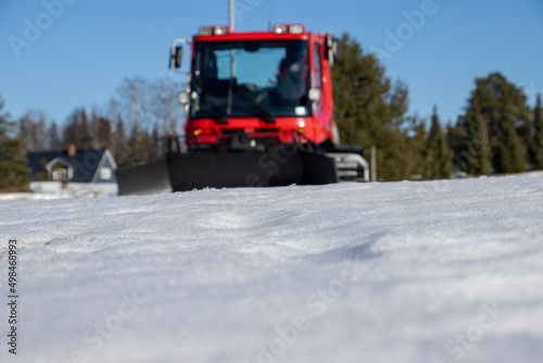 Wintertime background. Ski-track machine blurred.