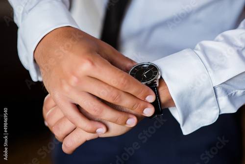 Businessman pointing at hand watch. timing concept