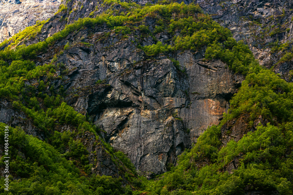 Dark stone heart in mountain with green trees background. Aurlandsfjord fjord landscape in Norway Scandinavia