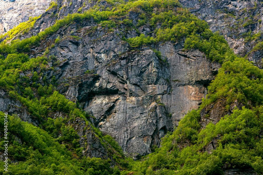 Dark stone heart in mountain with green trees background. Aurlandsfjord fjord landscape in Norway Scandinavia