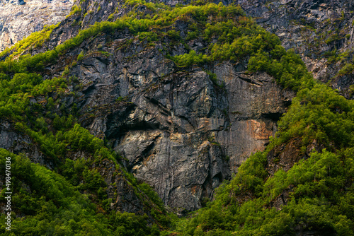 Dark stone heart in mountain with green trees background. Aurlandsfjord fjord landscape in Norway Scandinavia