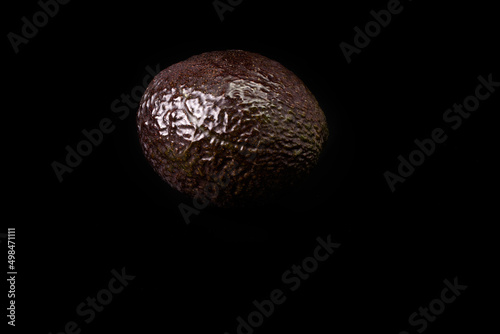 Ripe avocado on a black background. Vegan and vegetarian food